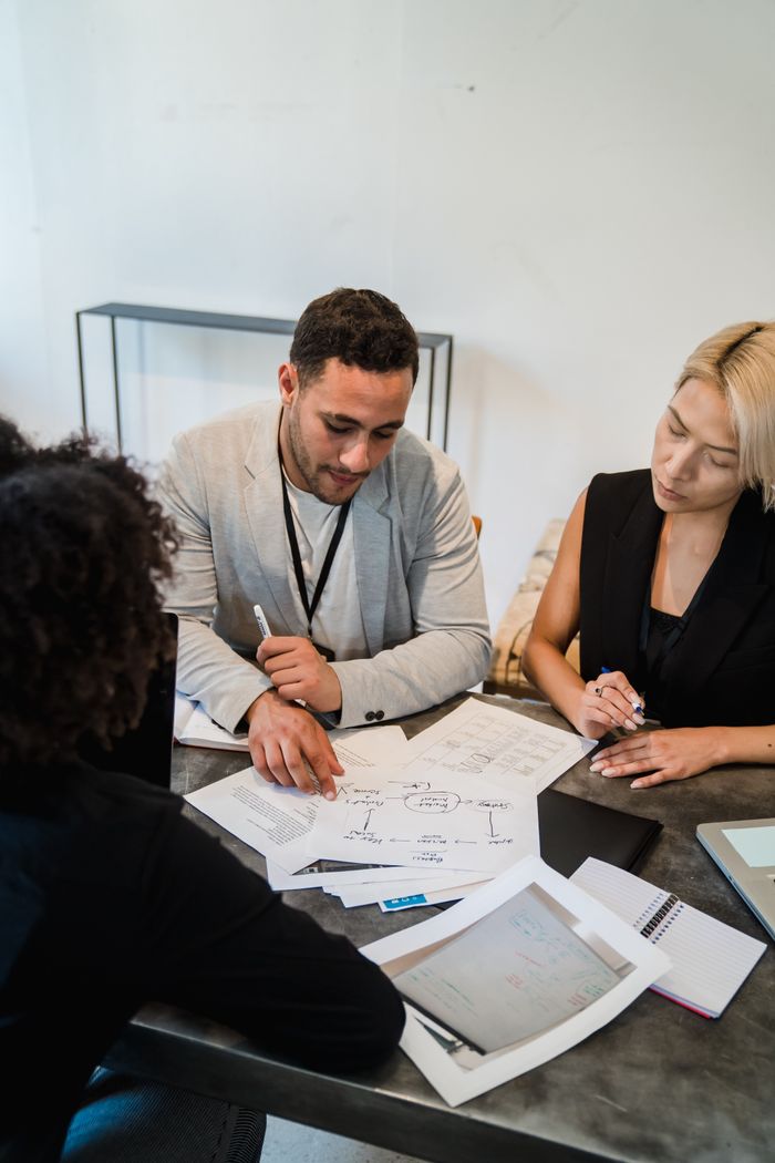 Project team reviewing plans and documents during a planning session